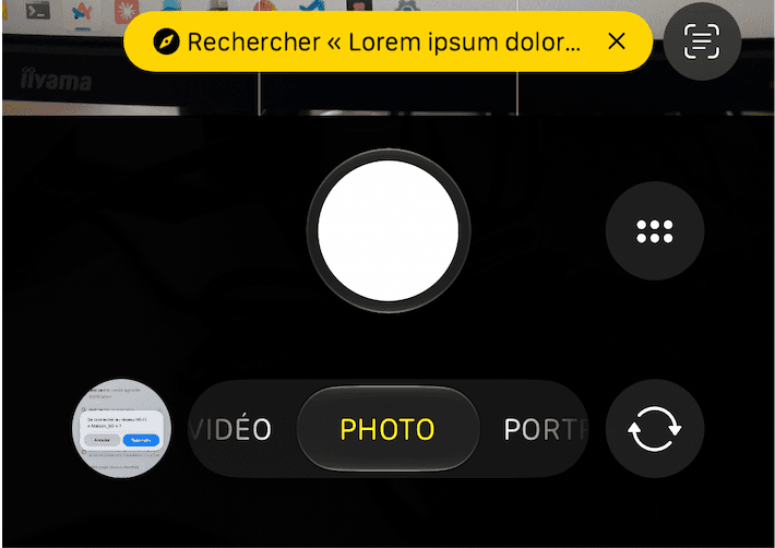 iPhone camera showing the decoded text read back in a banner